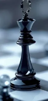 Black chess piece on checkered board in focus.