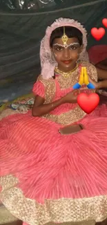 Girl in pink cultural dress with heart emojis.