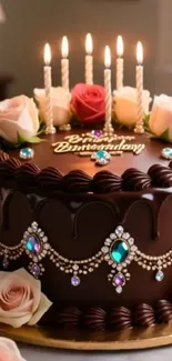 Elegant chocolate cake with roses and candles.