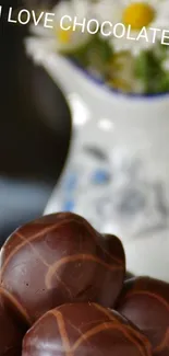 Chocolate truffles with daisies in vase wallpaper.