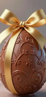 Chocolate egg with golden ribbon wallpaper.