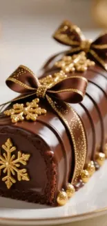 Chocolate Yule log with gold decorations.
