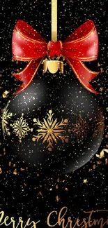 Elegant black ornament with red ribbon and gold snowflakes on Christmas wallpaper.