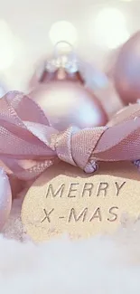 Merry Christmas tag with elegant pink ornaments on a cozy background.