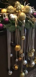 Christmas ornaments with gold, silver, and purple on green sprigs.