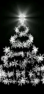 Glowing Christmas tree made of white snowflakes on a black background.