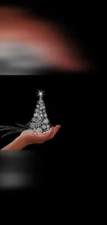 Elegant Christmas tree in hand on black background.