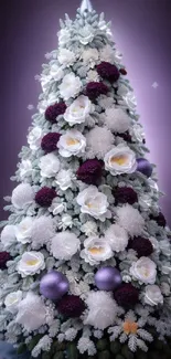 Elegant Christmas tree with white roses and purple accents on a snowy background.