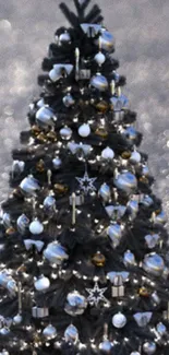 Elegant black Christmas tree with gold and silver ornaments.