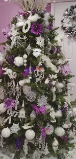 Elegant Christmas tree with purple and white decorations as mobile wallpaper.