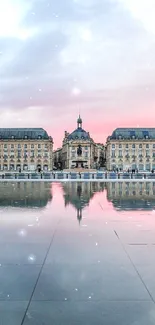 Elegant cityscape reflected in tranquil water with a pink and blue sunset.