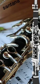 Clarinet laying on sheet music with artistic design.