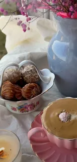 Elegant coffee setup with pink cup and pastries.