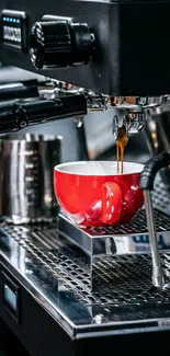 Red coffee cup on stainless steel espresso machine.