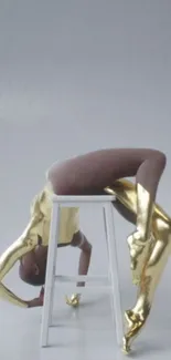 Graceful contortionist in gold suit with neutral background