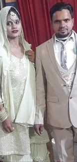 Elegant couple in formal attire posing for a portrait at an event.