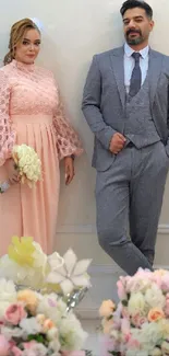 Elegant couple in stylish attire with floral decor.