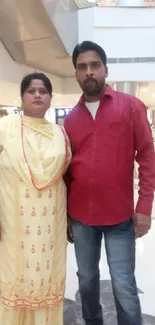 Elegant couple posing in a modern mall.