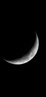 Crescent moon shining in a dark black sky background.