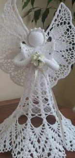 Elegant crochet angel with intricate lacework on display table.