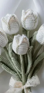 Elegant crocheted white tulip bouquet with green stems and lace ribbon.