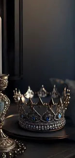 Dimly lit scene with a crown and candle on a decorative plate.