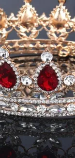 Close-up of a gold crown with red gemstones and diamonds.