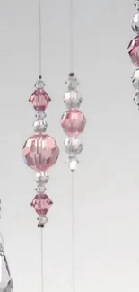 Elegant mobile wallpaper featuring pink and clear crystal beads.