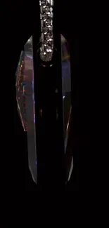 Elegant crystal pendant on a black background.