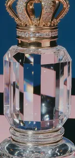 Crystal perfume bottle with gold crown on a striped background.