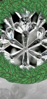 Crystal wreath with snowflake design and green pine border wallpaper.