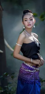 Elegant woman in traditional attire with a serene backdrop.