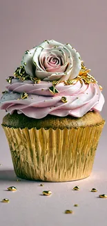 Gold foil cupcake with rose-topped cream swirl.