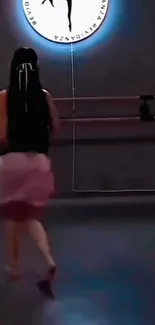 Back view of woman dancing in studio.