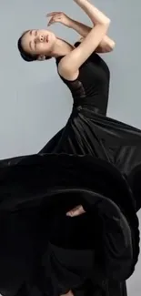 Elegant dancer in black dress with graceful pose.