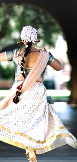 A dancer in traditional attire spins under a stone archway, exuding grace.