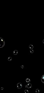 Dark wallpaper with floating bubbles on a black background.