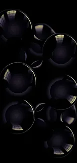 Dark glossy bubbles with reflective highlights on a black background.