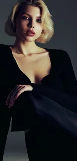 Elegant woman in dark attire on a mobile wallpaper.