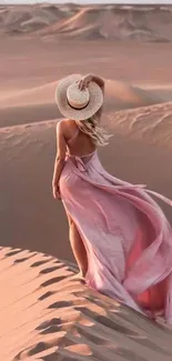 Woman in pink dress walking through scenic desert landscape.