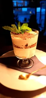 Elegant tiramisu dessert on a table with mint leaves.