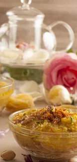 Elegant setup with dessert, tea, and pink rose.