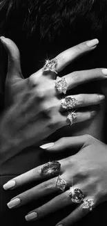 Graceful hands with diamond rings in black and white elegance.