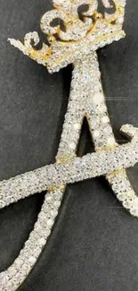 Diamond-encrusted letter A with golden crown on dark background.