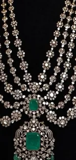 Elegant diamond and emerald necklace on black background.