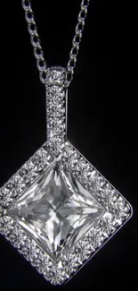 Elegant diamond pendant on black background.