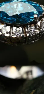 Close-up of a diamond ring with a blue gemstone and sparkling details.