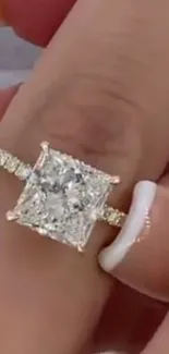 Close-up of a luxurious diamond ring on a finger.