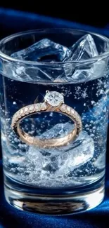 A diamond ring submerged in sparkling water with ice cubes.