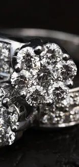 Two sparkling diamond rings on a dark background.